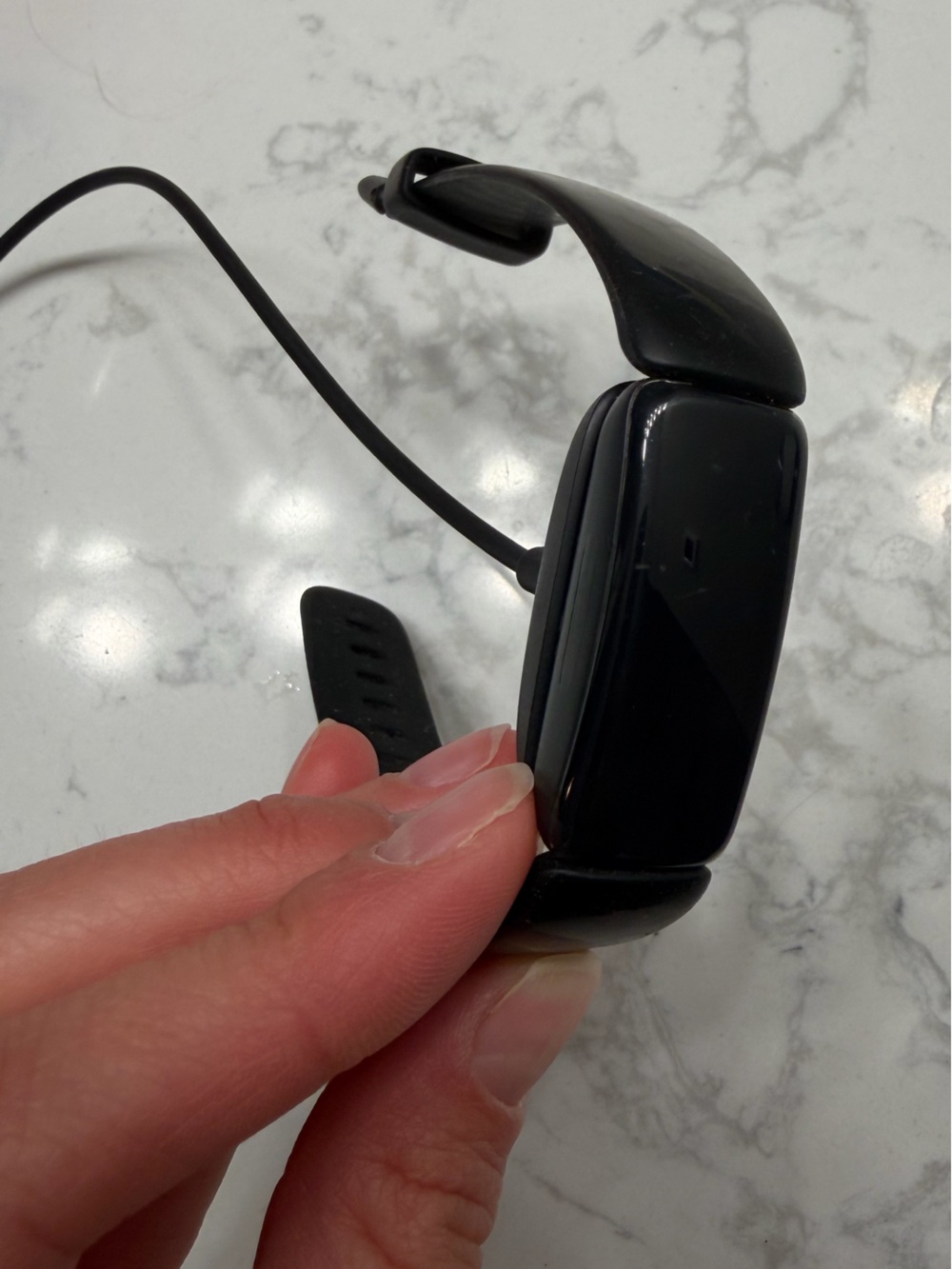 Black Fitbit Inspire Fitness Tracker Smartband with charging cord